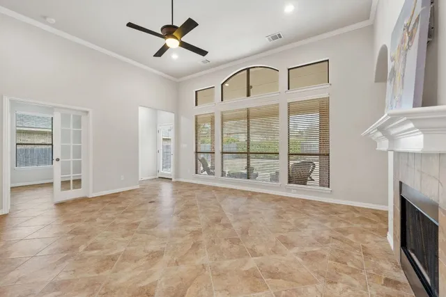 a view of an empty room with a fireplace and a window