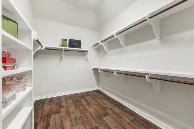 a view of walk in closet with empty racks