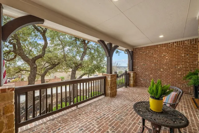 a view of a porch with furniture and garden