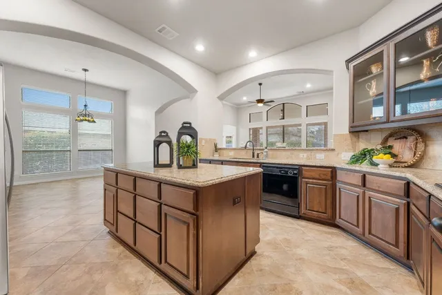 a kitchen with stainless steel appliances granite countertop a stove and a sink