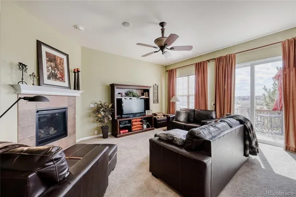 a living room with furniture and a view of kitchen