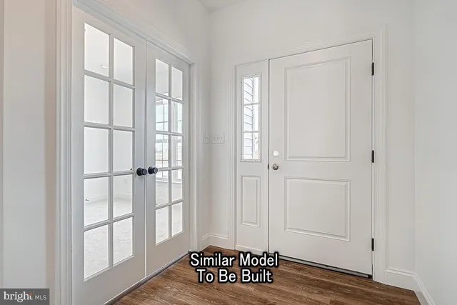 a view of a livingroom with wooden floor and windows with curtains