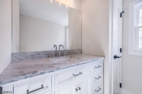 a bathroom with a sink and vanity