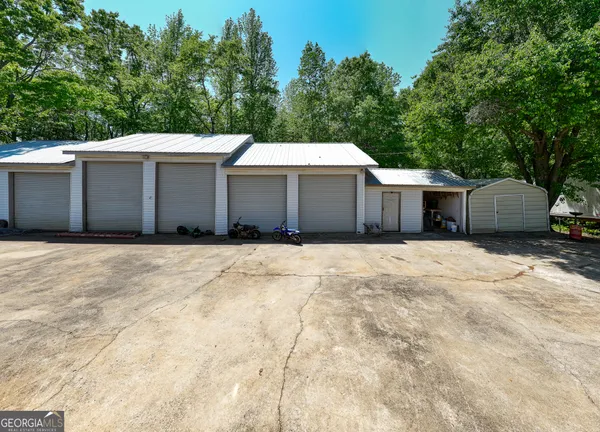 a view of a house with yard and sitting area