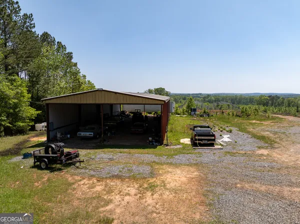 a view of a house with backyard and sitting area