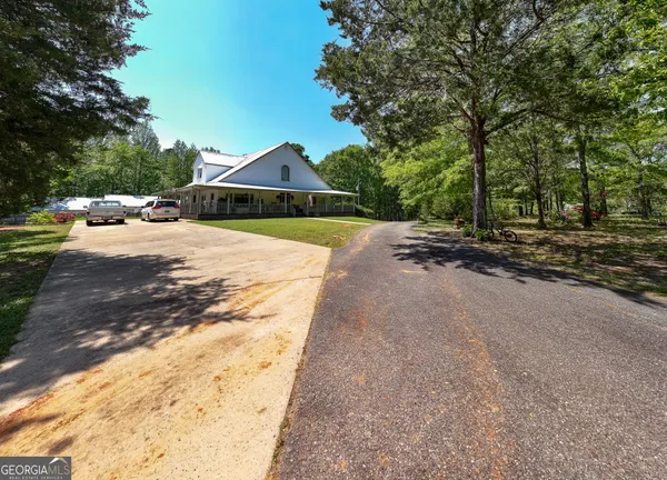 a backyard of a house with table and chairs