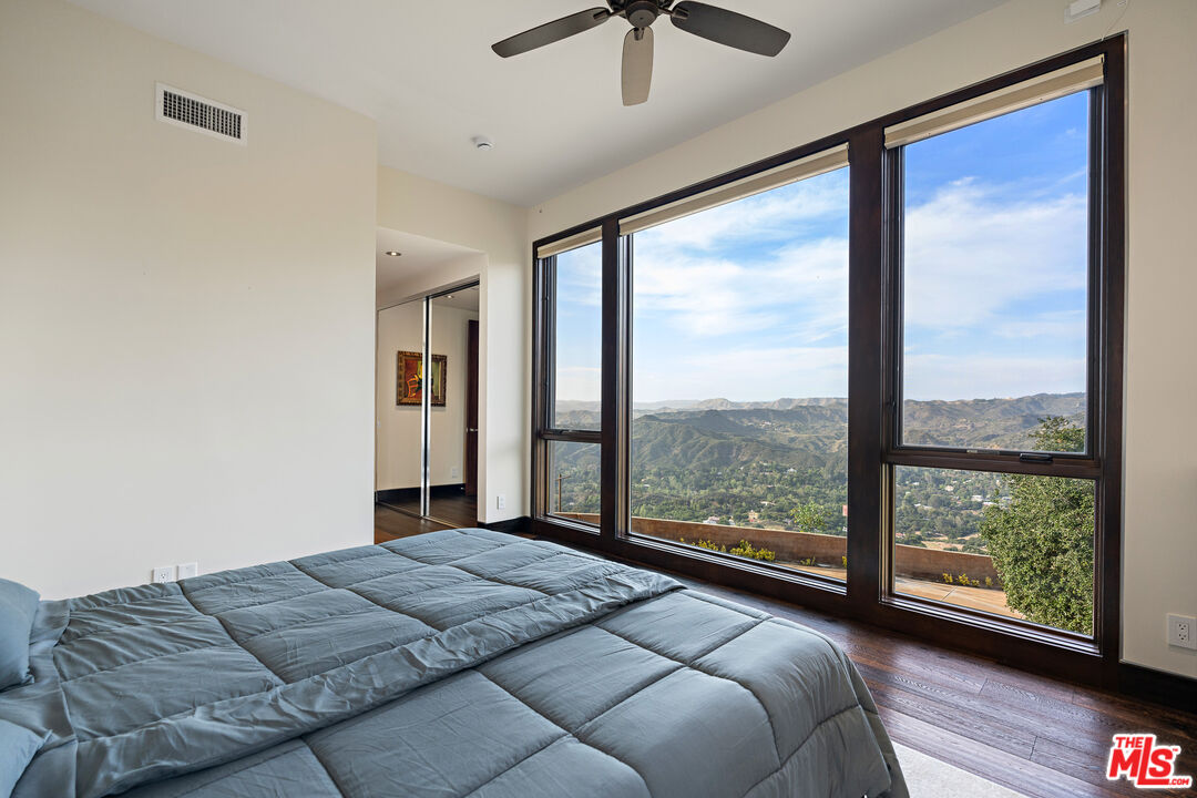 25155 Piuma Road Malibu, CA 90265 - Photo 17 of 29 a bedroom with a large bed and a large window