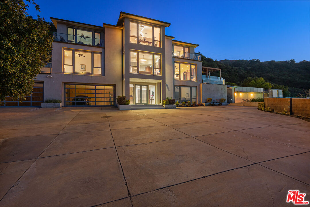25155 Piuma Road Malibu, CA 90265 - Photo 4 of 29 a view of a building with many windows and a yard
