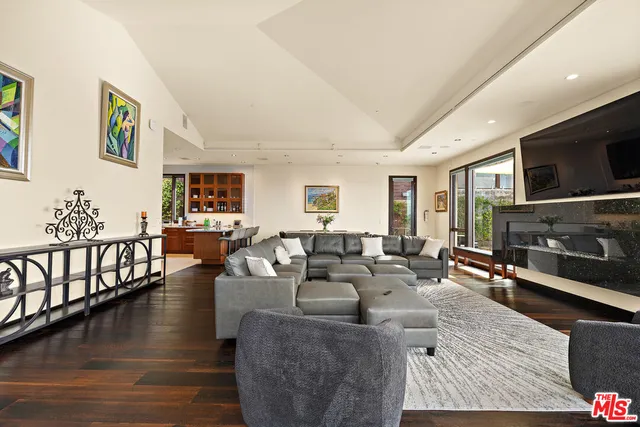 a living room with fireplace furniture and a flat screen tv