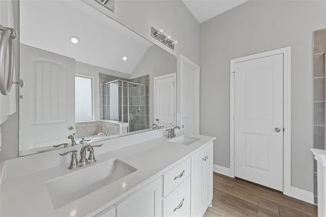 a bathroom with a double vanity sink mirror and