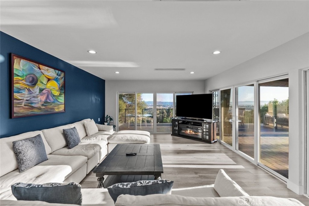 10126 Sully Drive Sun Valley, CA 91352 - Photo 15 of 34 a living room with furniture and a flat screen tv with kitchen view