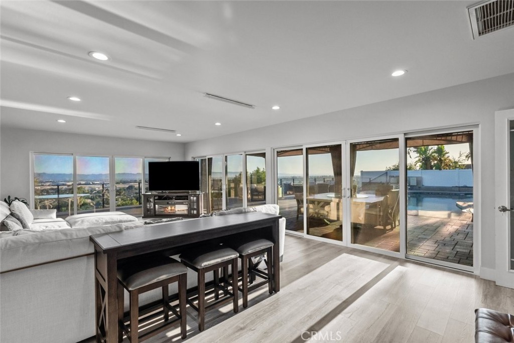 10126 Sully Drive Sun Valley, CA 91352 - Photo 17 of 34 a view of a workspace with furniture and a flat screen tv
