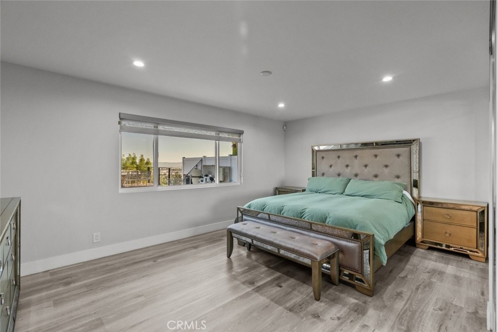 10126 Sully Drive Sun Valley, CA 91352 - Photo 18 of 34 a spacious bedroom with a bed and a window