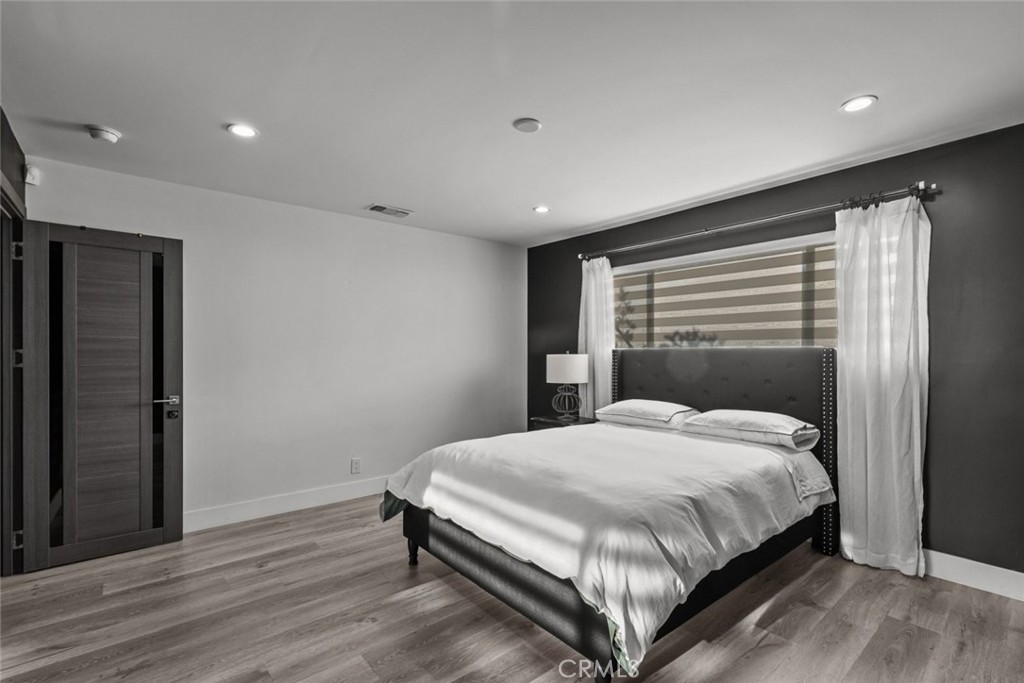 10126 Sully Drive Sun Valley, CA 91352 - Photo 22 of 34 a bedroom with a bed and a window