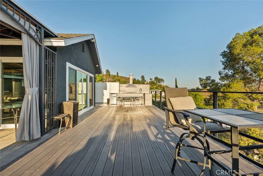 10126 Sully Drive Sun Valley, CA 91352 - Photo 30 of 34 a view of a balcony with furniture and wooden floor