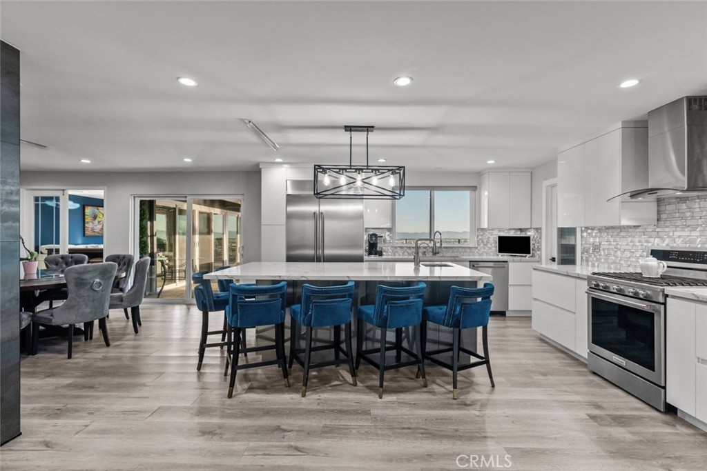 10126 Sully Drive Sun Valley, CA 91352 - Photo 10 of 34 a large kitchen with cabinets table and chairs