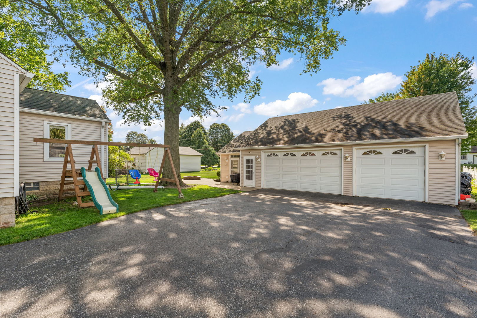 710 Elliott Street Beecher, IL 60401 - Photo 17 of 21 a view of a house with a yard and a large tree