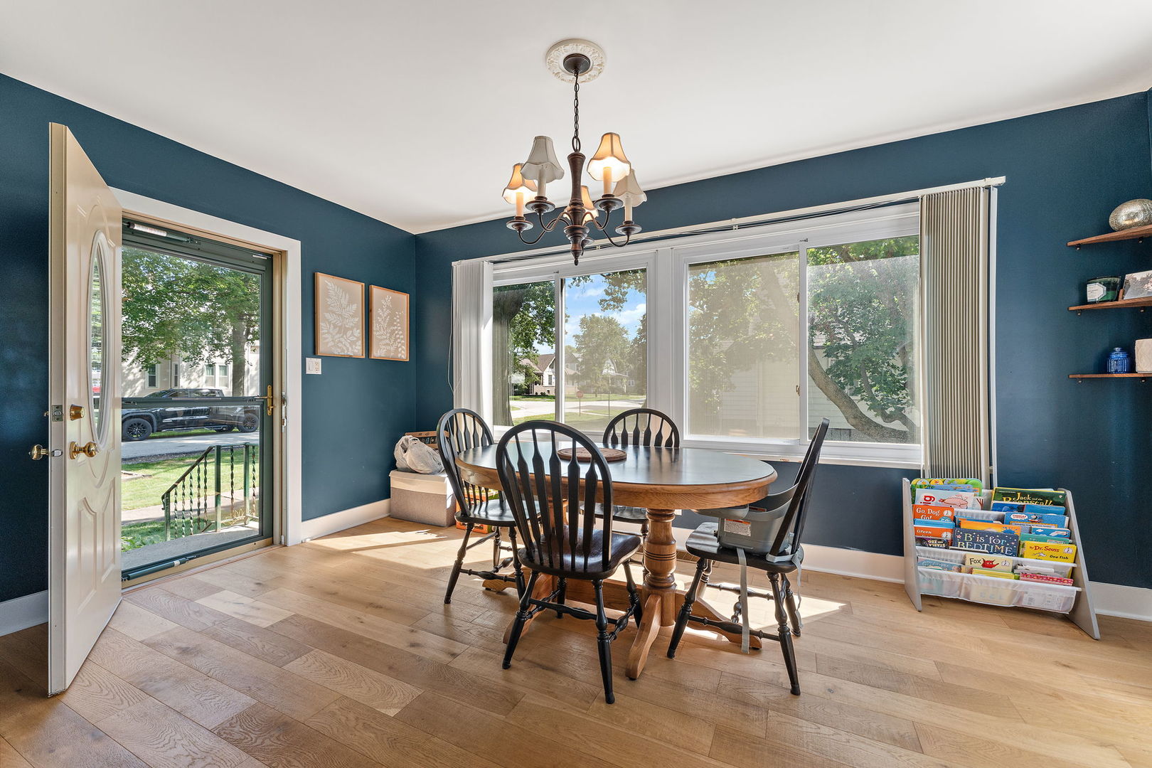 710 Elliott Street Beecher, IL 60401 - Photo 2 of 21 a dining room with furniture a chandelier and wooden floor