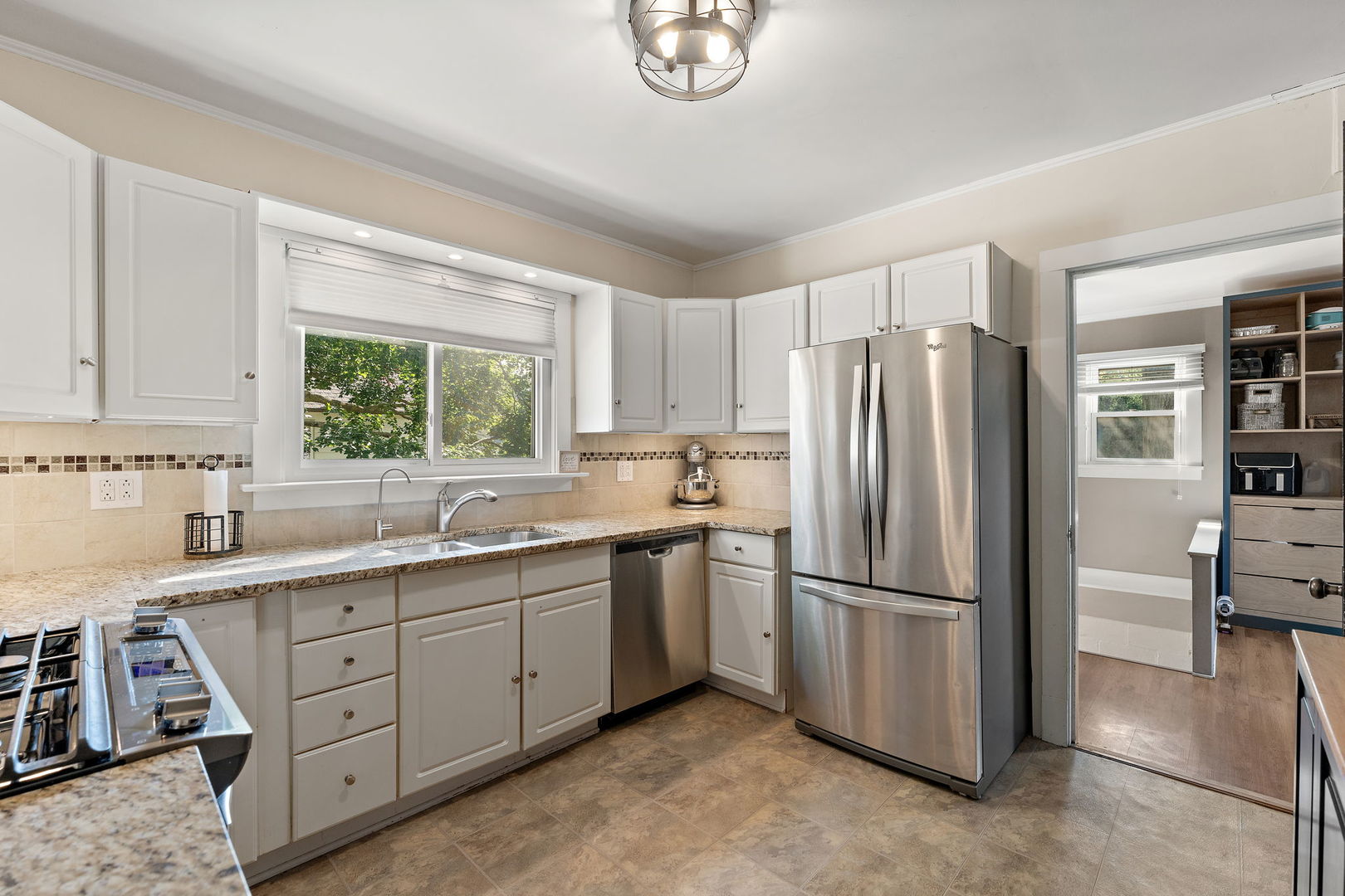 710 Elliott Street Beecher, IL 60401 - Photo 5 of 21 a kitchen with a refrigerator sink and cabinets