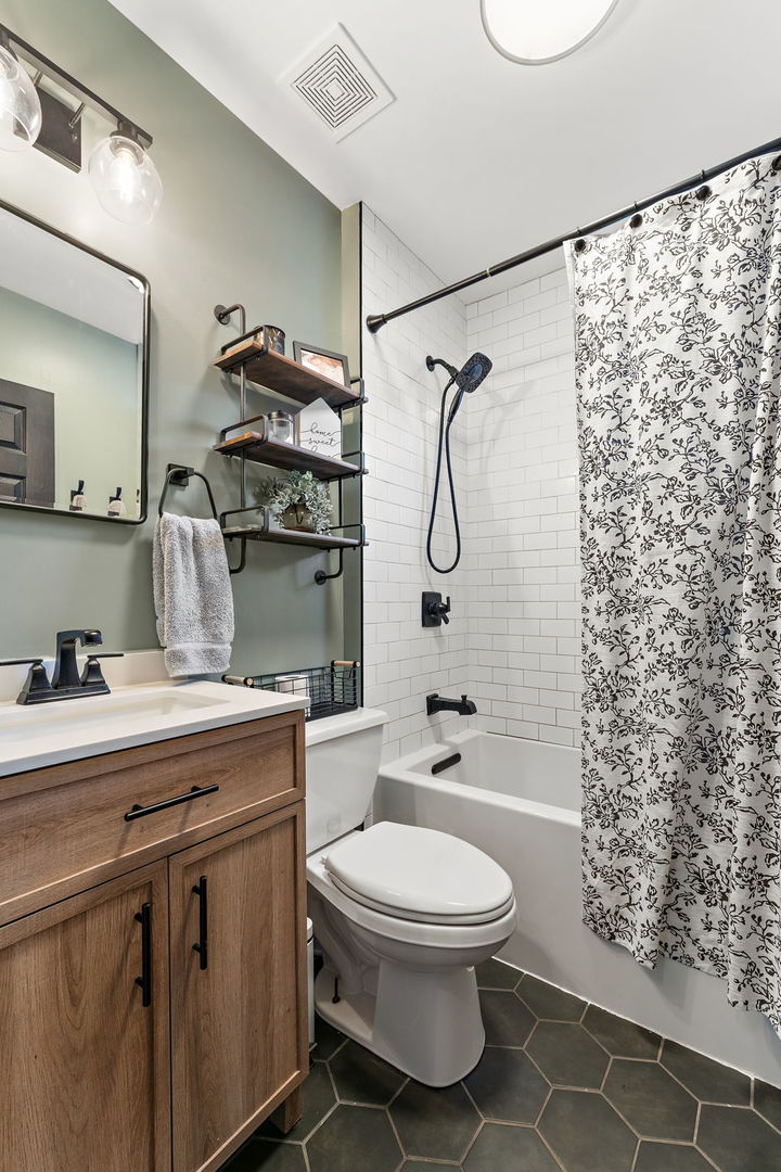 710 Elliott Street Beecher, IL 60401 - Photo 10 of 21 a bathroom with a granite countertop toilet sink and shower