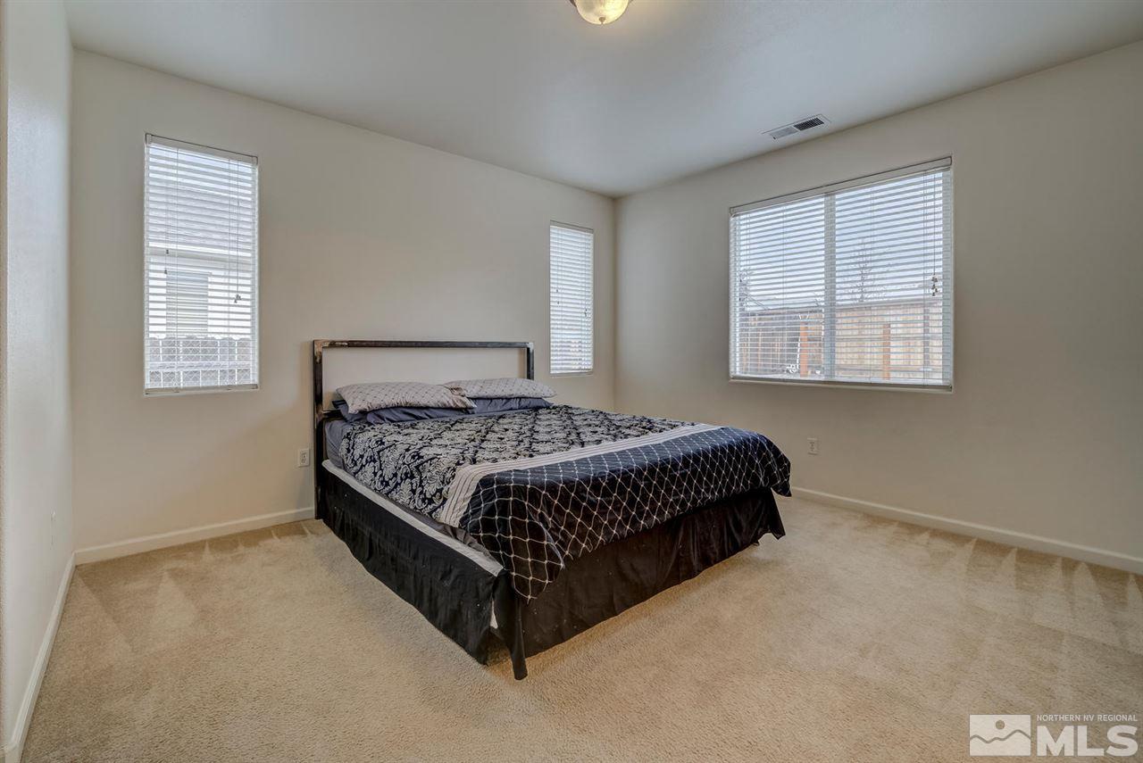 2271 Big Trail Circle Reno, NV 89521 - Photo 13 of 25 a bed sitting in a bedroom next to a window