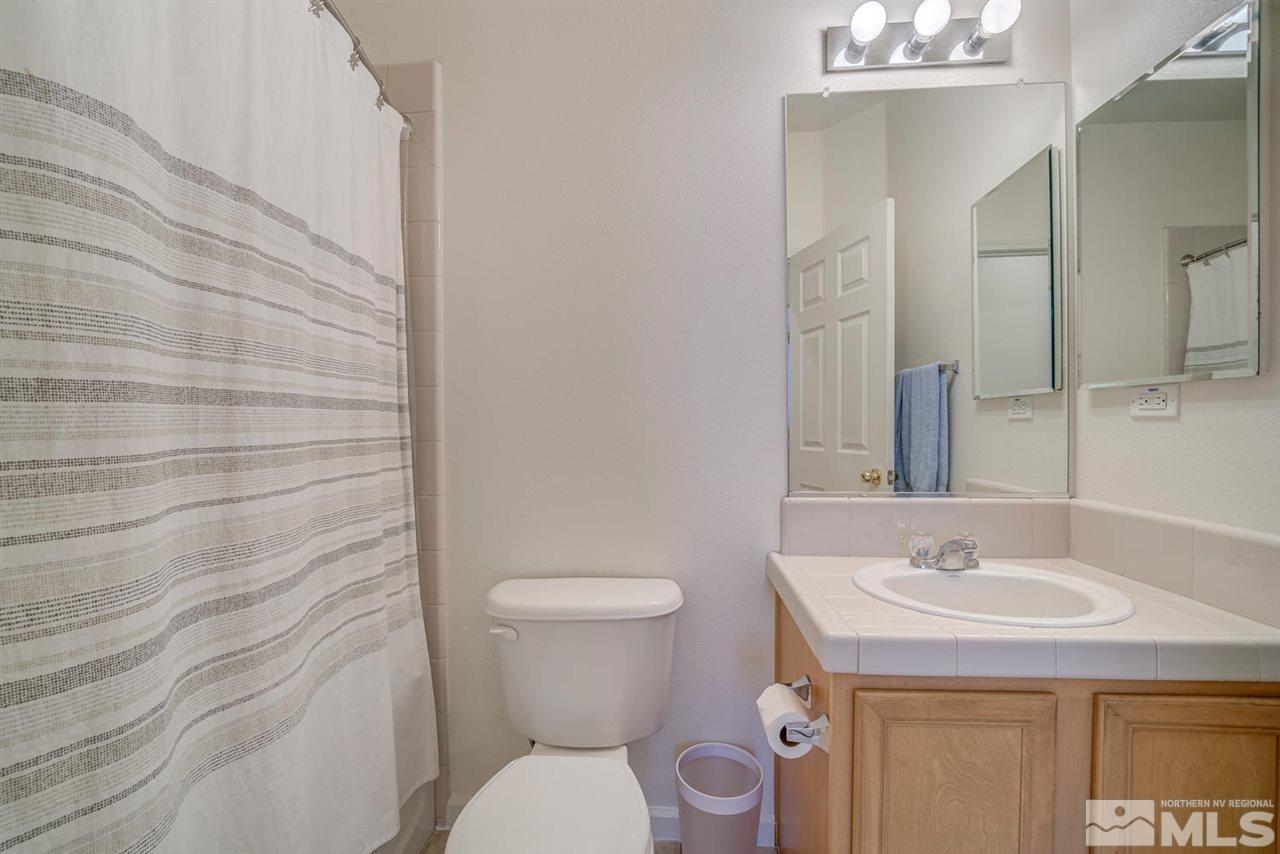 2271 Big Trail Circle Reno, NV 89521 - Photo 18 of 25 a bathroom with a sink a toilet and a mirror