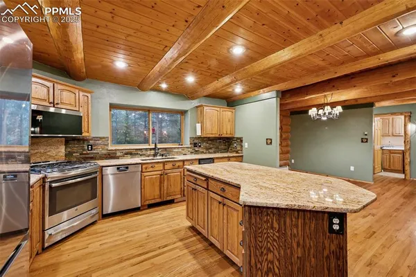 a kitchen with a stove sink and microwave