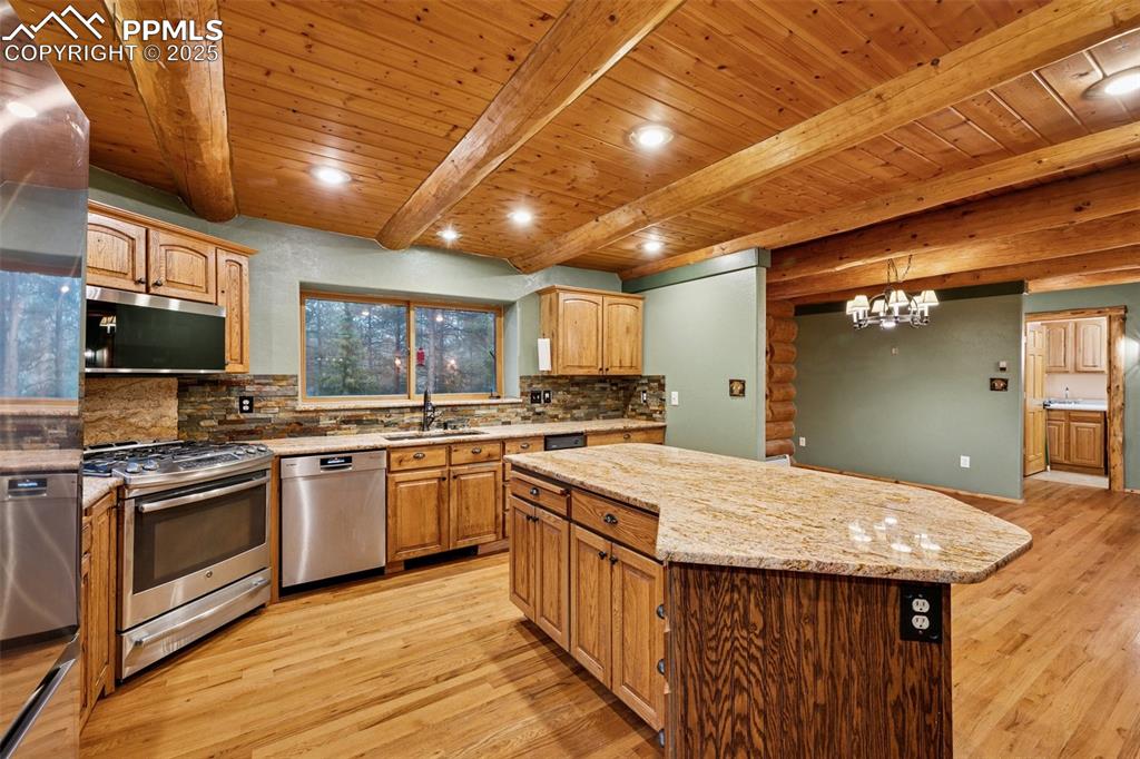 17522 Abert Ridge View Colorado Springs, CO 80908 - Photo 16 of 46 a kitchen with a stove sink and microwave
