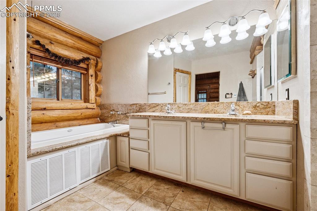 17522 Abert Ridge View Colorado Springs, CO 80908 - Photo 20 of 46 a bathroom with a sink and a mirror