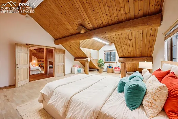 a bedroom with a bed and a large window