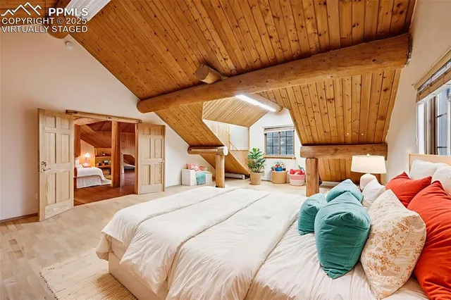 a bedroom with a bed and a large window