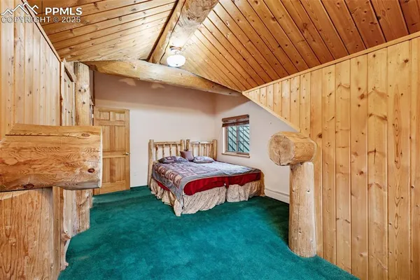 a spacious bedroom with a bed and a chandelier