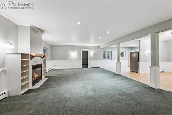 a view of an empty room with a kitchen