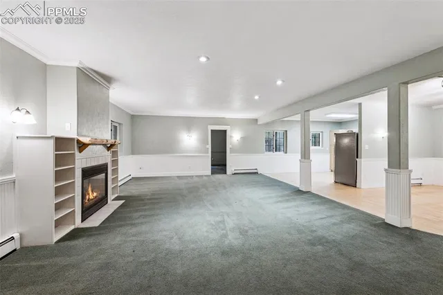 a view of an empty room with a kitchen