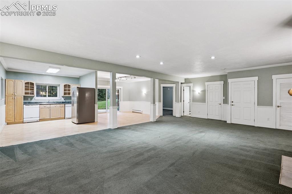 17522 Abert Ridge View Colorado Springs, CO 80908 - Photo 35 of 46 a view of an empty room with a kitchen