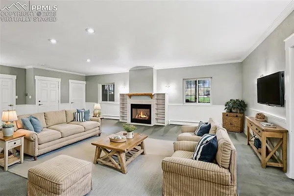 an empty room with fireplace and windows