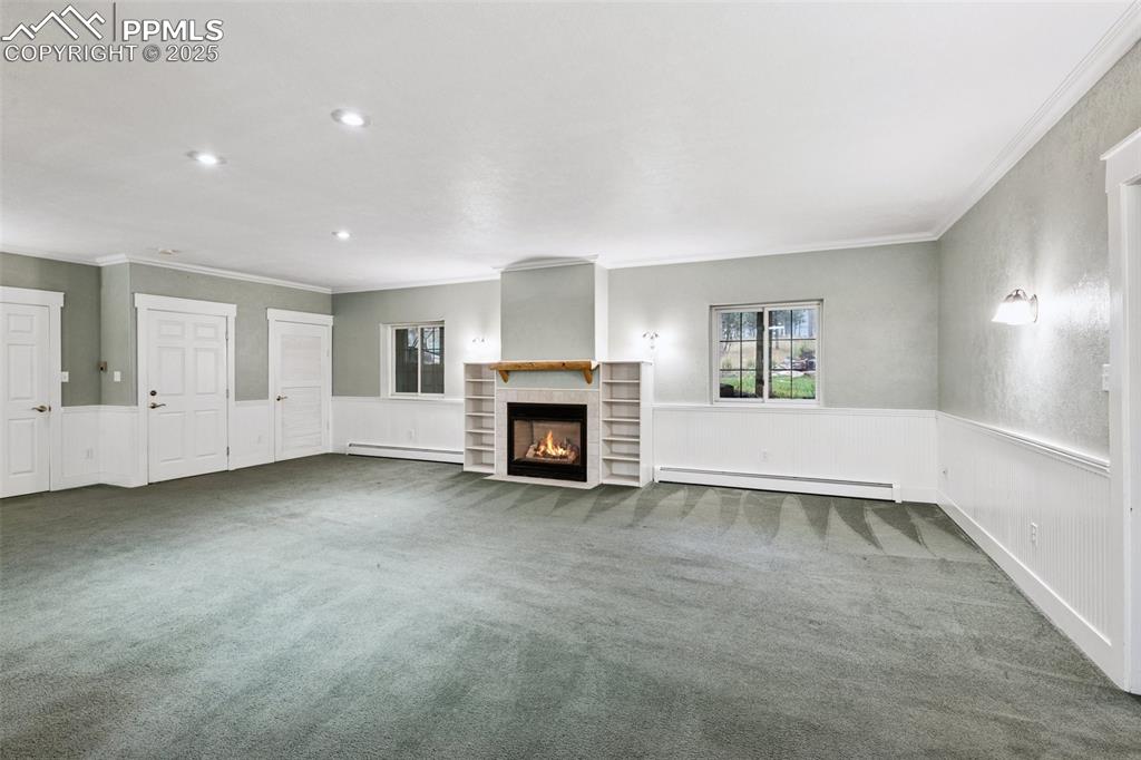 17522 Abert Ridge View Colorado Springs, CO 80908 - Photo 37 of 46 an empty room with fireplace and windows