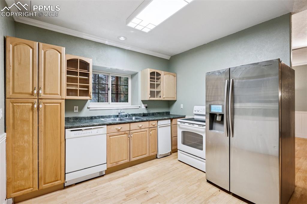 17522 Abert Ridge View Colorado Springs, CO 80908 - Photo 38 of 46 a kitchen with stainless steel appliances granite countertop a refrigerator and a sink