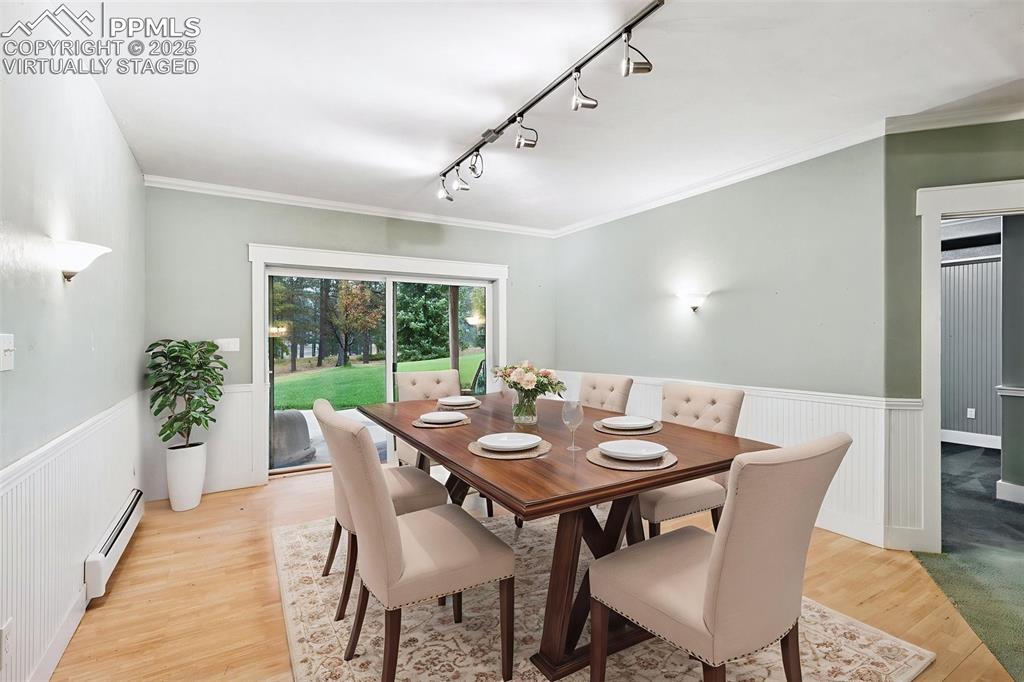 17522 Abert Ridge View Colorado Springs, CO 80908 - Photo 39 of 46 a view of a dining room with furniture window and wooden floor