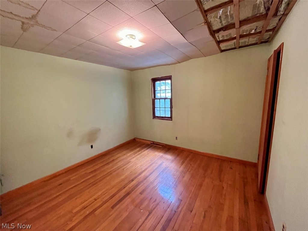 9003 Fosdick Road Cleveland, OH 44125 - Photo 7 of 16 Spare room with hardwood / wood-style floors
