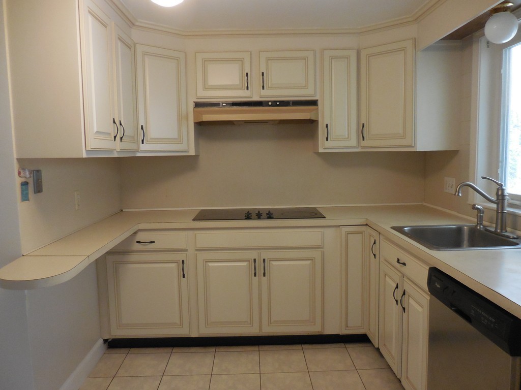 28 Lillian Road Lexington, MA 02420 - Photo 3 of 10 a kitchen with white cabinets and sink