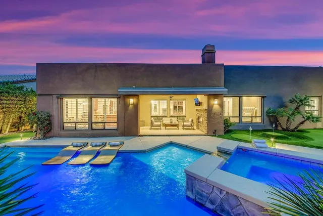 a view of an empty room with wooden floor and a floor to ceiling window