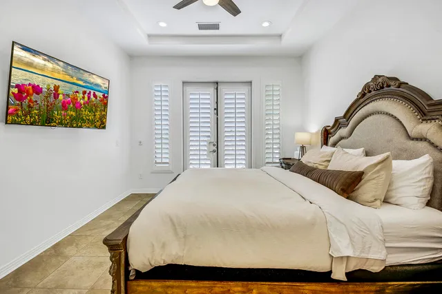 a bedroom with a bed and a window