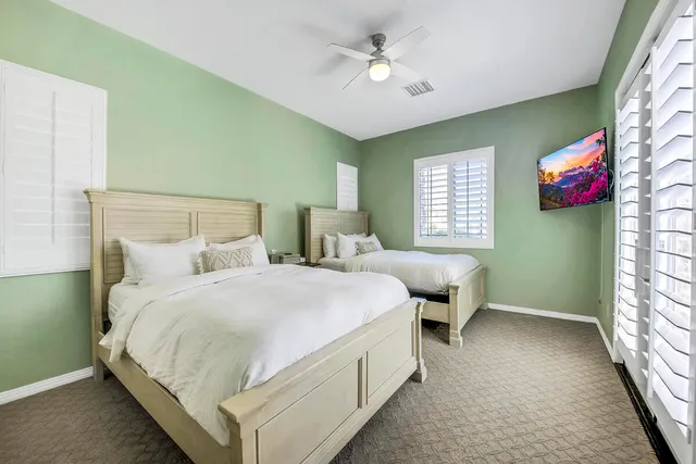 a bedroom with a bed and a flat screen tv