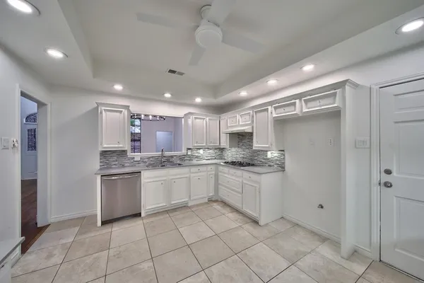 a kitchen with stainless steel appliances granite countertop a sink and cabinets