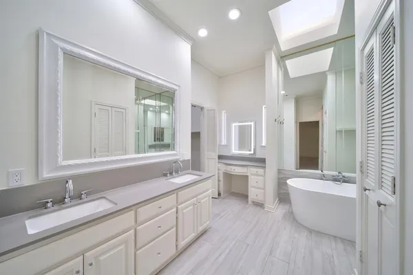 a bathroom with a double vanity sink a mirror and a