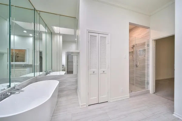 a bathroom with a tub shower and sink