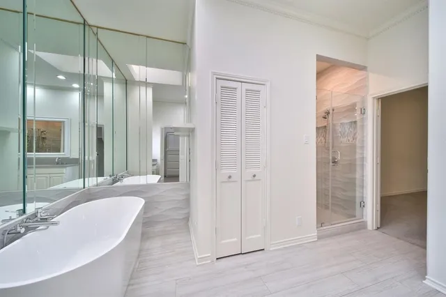 a bathroom with a tub shower and sink