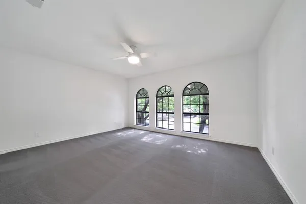 a view of a hallway to a livingroom with furniture