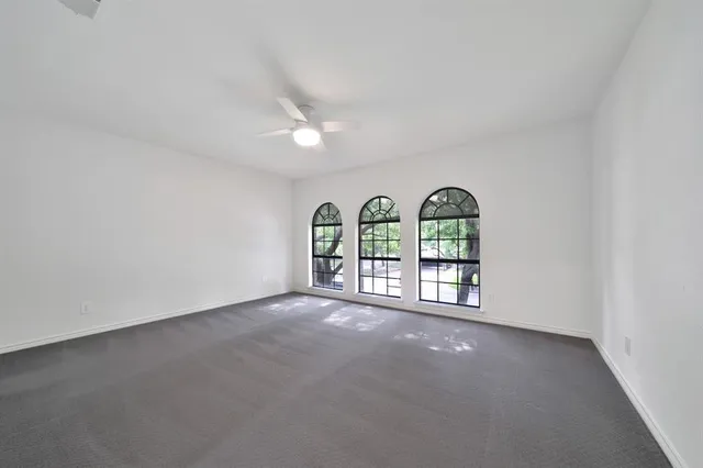 a view of a hallway to a livingroom with furniture